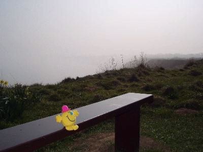 Sat on a clifftop bench, mist coming in off the sea